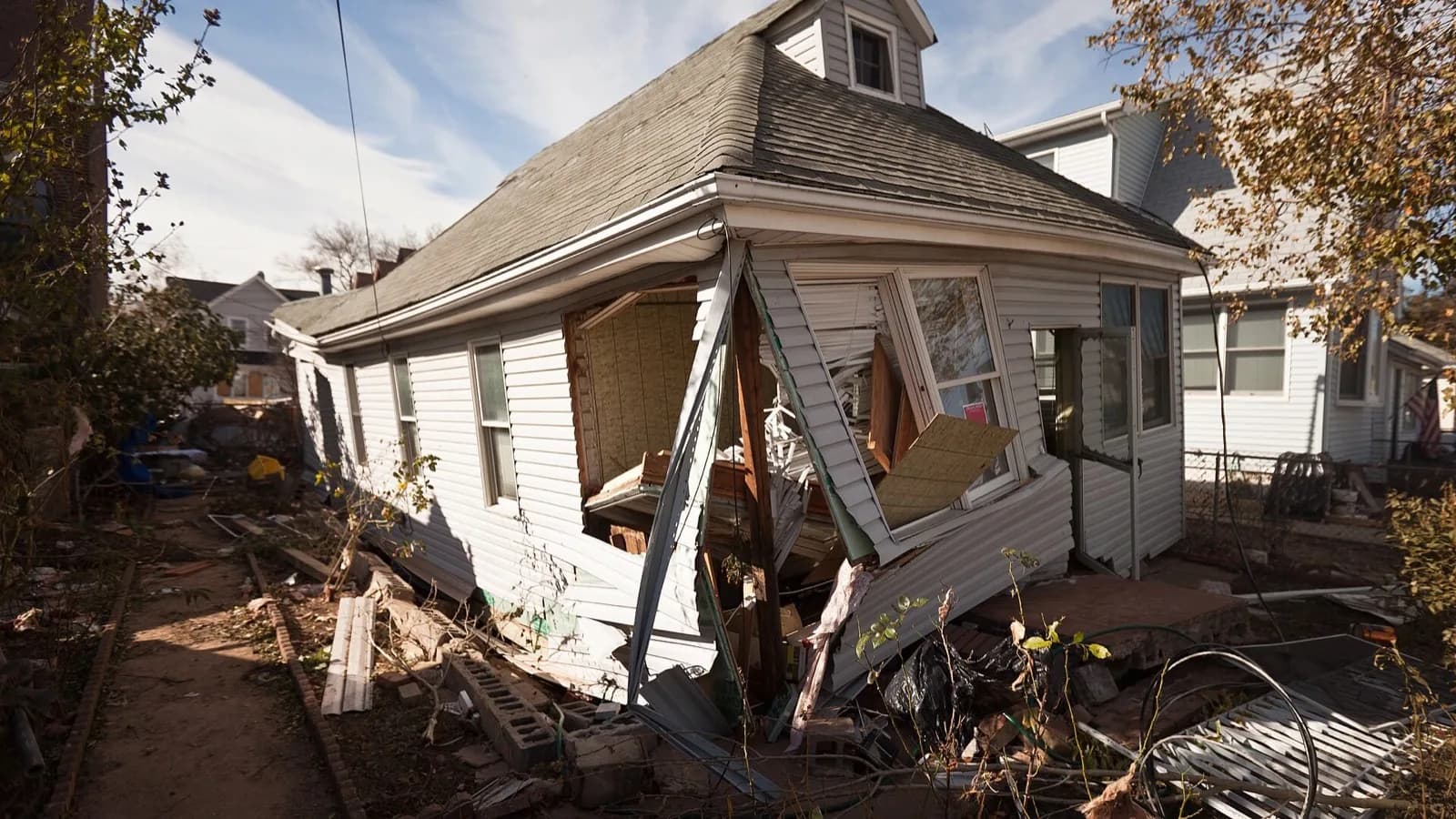 A house knocked off its foundation by Hurricane Sandy's storm surge, its siding torn away.